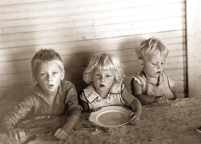 Children and adults receiving food at a local community food bank